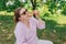 Funny brunette girl in sunglasses eating pizza on nature background. Attractive girl feels hungry and loves the taste