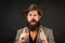 Funny brutal bearded hipster on isolated background. Close up photo of handsome funny man with beard in suit. Hand with