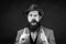 Funny brutal bearded hipster on isolated background. Close up photo of handsome funny man with beard in suit. Hand with