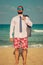 Funny businessman on the beach