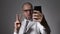 Funny businessman manager makes selfie phone.