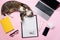 Funny cat lying on the office desk and playing with crumpled paper balls.