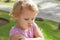 Funny Caucasian blond baby girl resentfully pouts