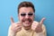Funny caucasian man with retro mustache and sunglasses giving a thumbs up
