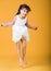 Funny cheerful beautiful girl bounces in studio