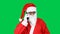 Funny, cheerful and smiling Santa Claus talking on cell phone.