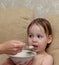 Funny child eating porridge delicious nutritious oatmeal