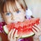 Funny child eating watermelon