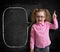 Funny child in eyeglasses standing near school chalkboard