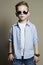 Funny child.fashionable little boy in sunglasses. jeans