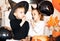 funny child girl and boy in witch and evil costumes for Halloween eating candies lolly pops and have fun.