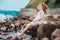 Funny child girl playing with water splash on the beach. Traveling on summer vacation.