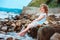 Funny child girl playing with water splash on the beach. Traveling on summer vacation.