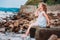 Funny child girl playing with water splash on the beach. Traveling on summer vacation.