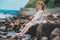 Funny child girl playing with water splash on the beach. Traveling on summer vacation.