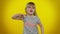 Funny child girl in striped t-shirt listening music, smiling dancing to disco music, having fun