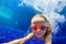 Funny child in goggles dive in swimming pool