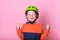 Funny child in helmet with hands up. Happy kid having fun outdoor. Kid dreams and imagin big. Portrait of proud blond