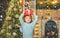 Funny child holding a red gift box with both hands. Christmas Celebration holiday. Happy little child dressed in winter