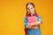 Funny child school girl girl on yellow background