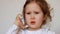 Funny child speaks on the smartphone closeup. Baby girl talking on the mobile phone.