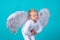 Funny child wearing angel wings with fun smile happy expression.