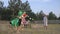 Funny children, little girl in carnival costume plays game with her friends catches and runs after them in forest glade