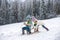 Funny children in snow ride on sled. Winter outdoors games. Happy Christmas family vacation concept. Kids enjoy the