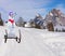 Funny christmas concept of a party snowman wearing a hat and roller tongue sliding down the ski hill slope on a sleigh