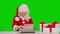 Funny Christmas woman writing letter on typewriter, isolated on green. Many garlands. Christmas , winter holidays and