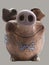 Funny clay piggy bank. Front view