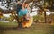 Funny climbing boy. Happy child playing in the garden climb on the tree.