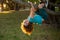 Funny climbing boy. Kid climb high tree in summer park.