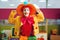 Funny clown dressed in colorful hat and costume