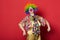 Funny clown with glasses on red