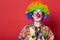 Funny clown with glasses on red