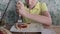 A funny clumsy boy cutting a piece of pizza with a fork and knife in his plate at a restaurant, lunch time