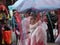 funny costumed group consisting of young women. In the background costumed spectators