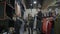 Funny couple doing shopping in weekend and girlfriend gives her boyfriend lots of clothes to hold for her on black friday -