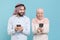 Funny couple friends arabian muslim man wonam in keffiyeh kafiya ring igal agal hijab clothes isolated on blue