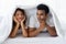 Funny couple lying, talking, hiding in white blanket on white bed  in the bedroom. Relation in family. Relaxing in the morning