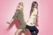 Funny crazy girls pose in torn clothes on pink background. Beauty, look concept. Fashion, style, vogue.