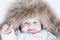 Funny cute baby girl wearing huge winter hat