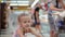 Funny cute child pushing shopping cart in supermarket