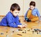 Funny cute children playing toys at home, boys happy smiling, first education role lifestyle