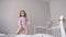 Funny cute little girl jumping and having fun on the bed