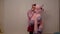 Funny and cute young transgender girl holding a pink stuffed unicorn and sucking her thumb, Adult infantile behavior, person with