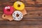 Funny decorated donuts on wooden background.