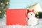 Funny decorative snowman and blank red card on table