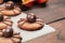 Funny delicious ginger biscuits for Halloween on the table. Set of chocolate Halloween spider cookies on paper for bake and wooden